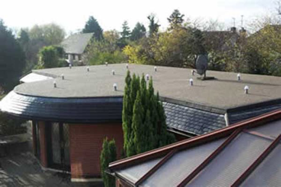 Low-slope commercial roof with new membrane and vents
